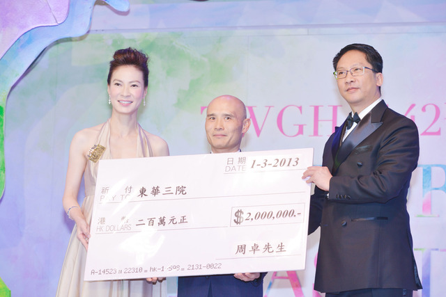 东华三院陈文绮慧主席（ 左）陪同律政司司长袁国强SC 太平绅士（ 右）代表东华接受周国顺先生代表捐款人周卓先生捐款予本院社会服务科的二百万元捐款支票