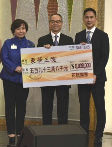 图四为民政事务局局长刘江华太平绅士(中)在东华三院何超蕸主席(左)的陪同下，代表东华三院接受花旗集团所捐赠的五百九十三万八千元捐款支票。