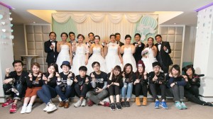 Group photo of Image Pro trainees and ethnic minority couples dressed in wedding gowns and tuxedos.