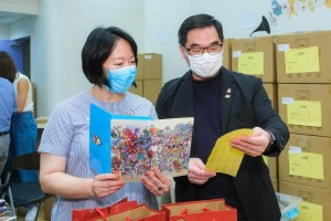 图四：东华三院文頴怡主席（左）及苏祐安行政总监（右）检视抗疫包内的口罩套。